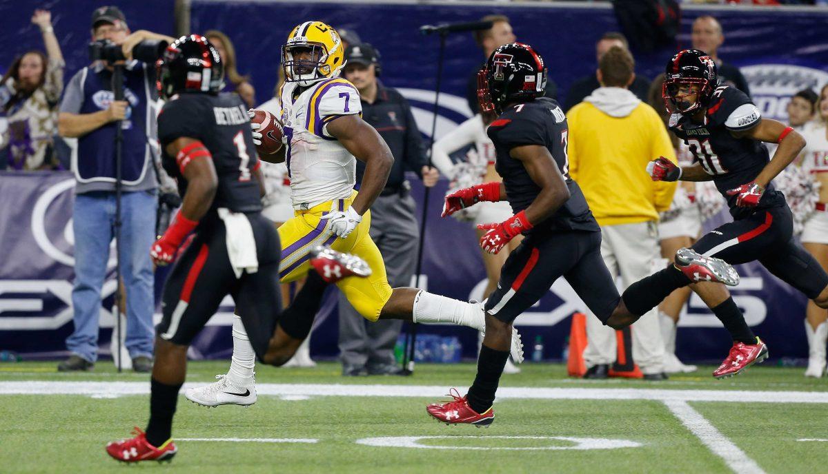 LSU running back Leonard Fournette (7) looks over his shoulder at Texas Tech defensive backs Jah'Shawn Johnson (7) and Justis Nelson (31) and defensive back Nigel Bethel (1) as he runs for a 44-yard touchdown during the first half of the Texas Bowl NCAA college football game Tuesday, Dec. 29, 2015, in Houston. (AP Photo/Bob Levey)