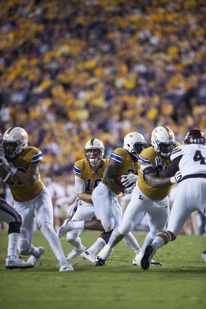 LSU junior quarterback Danny Etling (16) hands the ball off to junior running back Leonard Fournette (7) during the Tigers 23-20 victory over Mississippi State on Sept. 17, 2016 at Tiger Stadium.