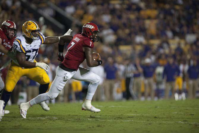 LSU junior defensive end Davon Godchaux (57) attempts to tackle Jacksonville State University redshirt senior quarterback Eli Jenkins (7) during Tigers' 34-13 Victory against Jacksonville State University on Sept. 10, 2016, in Death Valley.