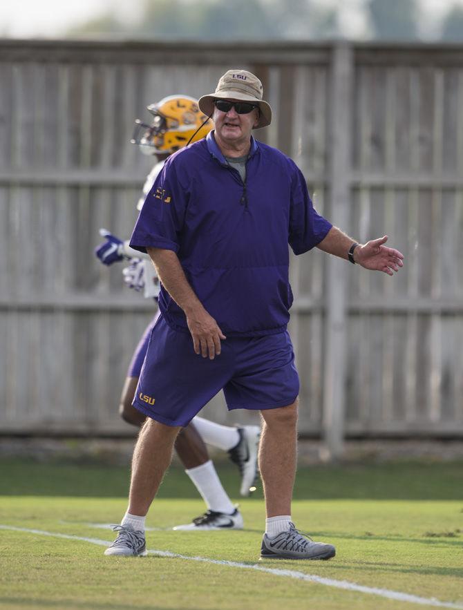 LSU football offensive coordinator and quarterback coach Steve Ensminger talks to players about the drill being run during an outdoor practice on Tuesday Sept. 27, 2016, on the LSU football practice fields at the LSU Football Practice and Training Facilities.