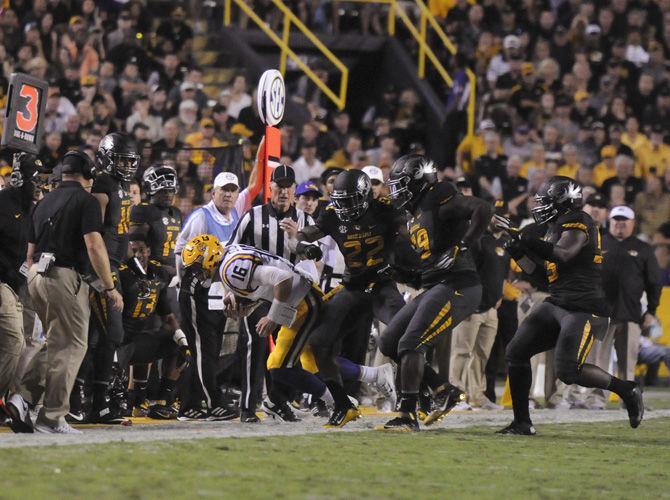 LSU junior quarterback Danny Etling (16) is forced into the sidelines by Missouri junior defensive back Anthony Sherrils (22) and freshman linebacker Trey Baldwin (29) on Saturday, Oct. 1, 2016, during the LSU Tigers' 42-7 victory against the Missouri Tigers in Tiger Stadium.