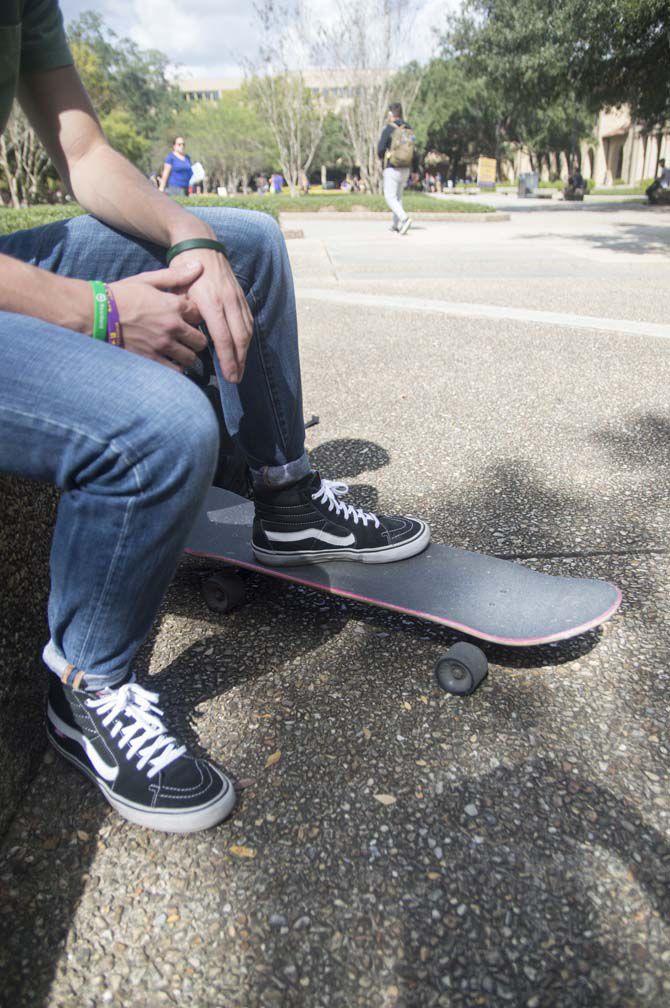 LSU Junior Robert Henry sits with his skateboard on Oct. 27, 2016 in the Quad on LSU campus.