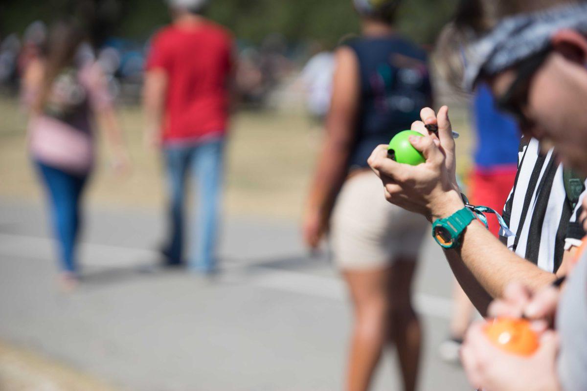 Festival-goers add their names to balls that will be placed in the VH1 Save The Music installation on Saturday Oct. 29, 2016 at the Voodoo Music and Arts Experience (Voodoo Festival) at City Park in New Orleans, Louisiana.