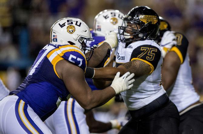 LSU junior defensive end Davon Godchaux (57) and Southern Miss offenisve lineman Oliver Bates (75) clash at the line of scrimmage on Saturday, Oct. 15, 2016, during the Tigers' game against the Golden Eagles in Tiger Stadium.