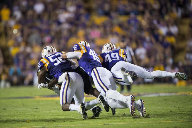 LSU senior linebacker Kendell Beckwith (52), senior linebacker Tashawn Bower (46) and sophomore linebacker Arden Key (49) pile up on Southern Miss junior running back George Pain (24) during the LSU 45-10 win against Southern Mississippi on Saturday Oct. 15, 2016, in Tiger Stadium.