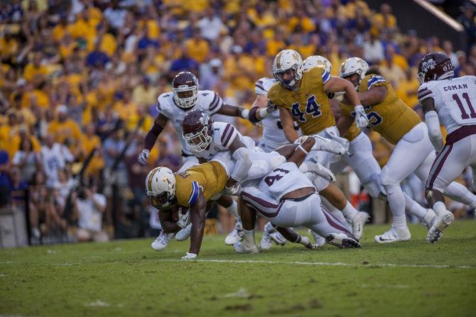 LSU junior running back Leonard Fournette (7) fights through the Mississippi State defense on Sept. 17, 2016 at Tiger Stadium.