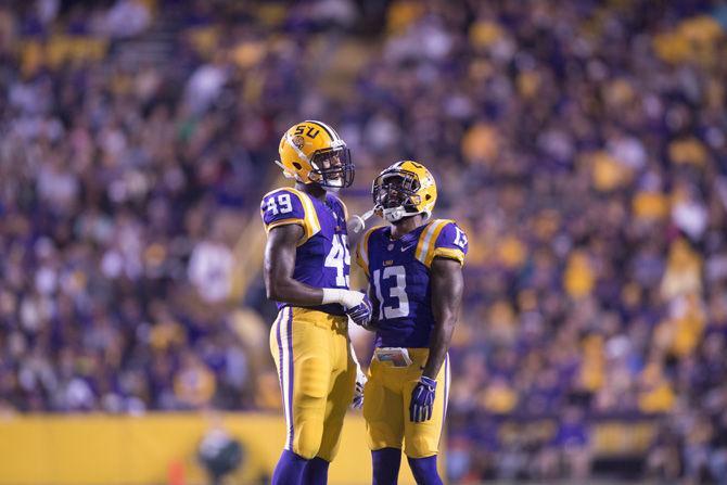 LSU freshman defensive end Arden Key (49) and junior defensive back Dwayne Thomas (13) shake hands Saturday, Sept. 3, 2015, during the Tigers' 44-22 victory over Eastern Michigan University in Tiger Stadium.