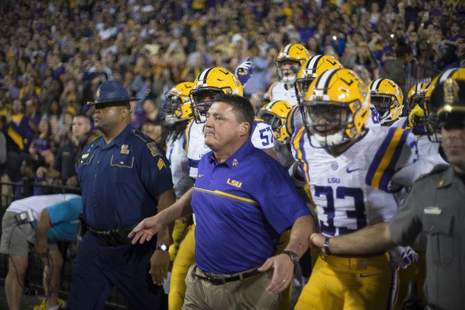 Interim head coach Ed Orgeron leads the Tigers on to the field on Saturday Oct. 22, 2016 before their 38-21 victory over Ole Miss at Tiger Stadium.