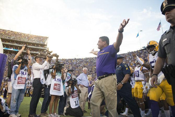 LSU interim head coach Ed Orgeron raises his arms as fans cheer on Saturday, Oct. 1, 2016, during the Tigers' 42-7 victory against Missouri in Tiger Stadium.