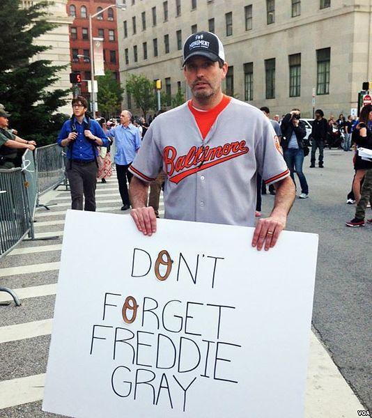 A demonstrator, wearing the uniform of the Orioles baseball team on the street in Baltimore.