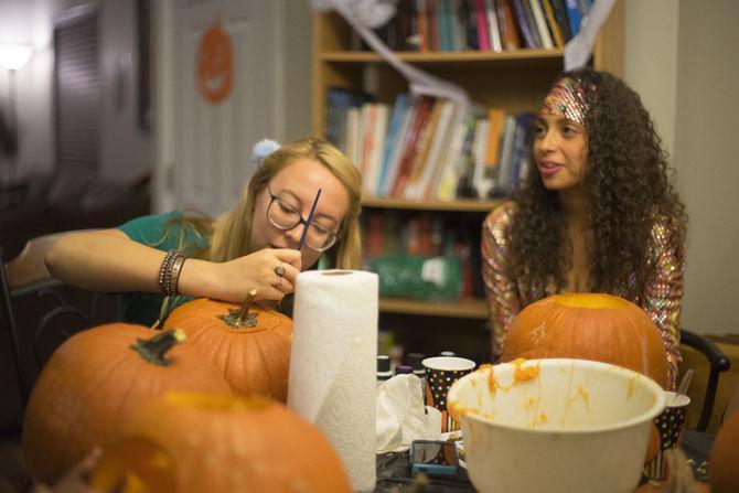 Partygoers carving pumpkins on Oct. 23, 2016 at a Halloween themed get-together.