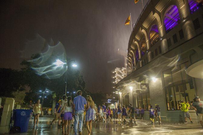 Spectators flee the stadium after the LSU vs. McNeese St. game was canceled due to rain and lighting in the area on Sept. 05, 2015, outside Tiger Stadium.