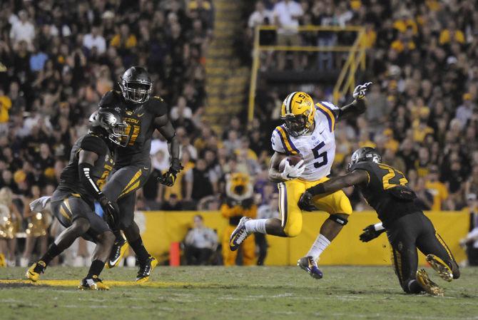 LSU sophomore running back Derrius Guice (5) attempts to dodge tackles from Missouri's defense on Saturday, Oct. 1, 2016, during the Tigers' 42-7 victory against Missouri in Tiger Stadium.