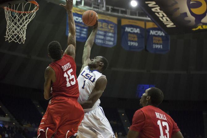 LSU junior forward Duop Reath (1) attempts to dunk the ball over Houston junior forward Devin Davis (15) during the Tigers' 84-65 win against the University of Houston on Tuesday, Nov. 29, 2016 in the Pete Maravich Assembly Center.