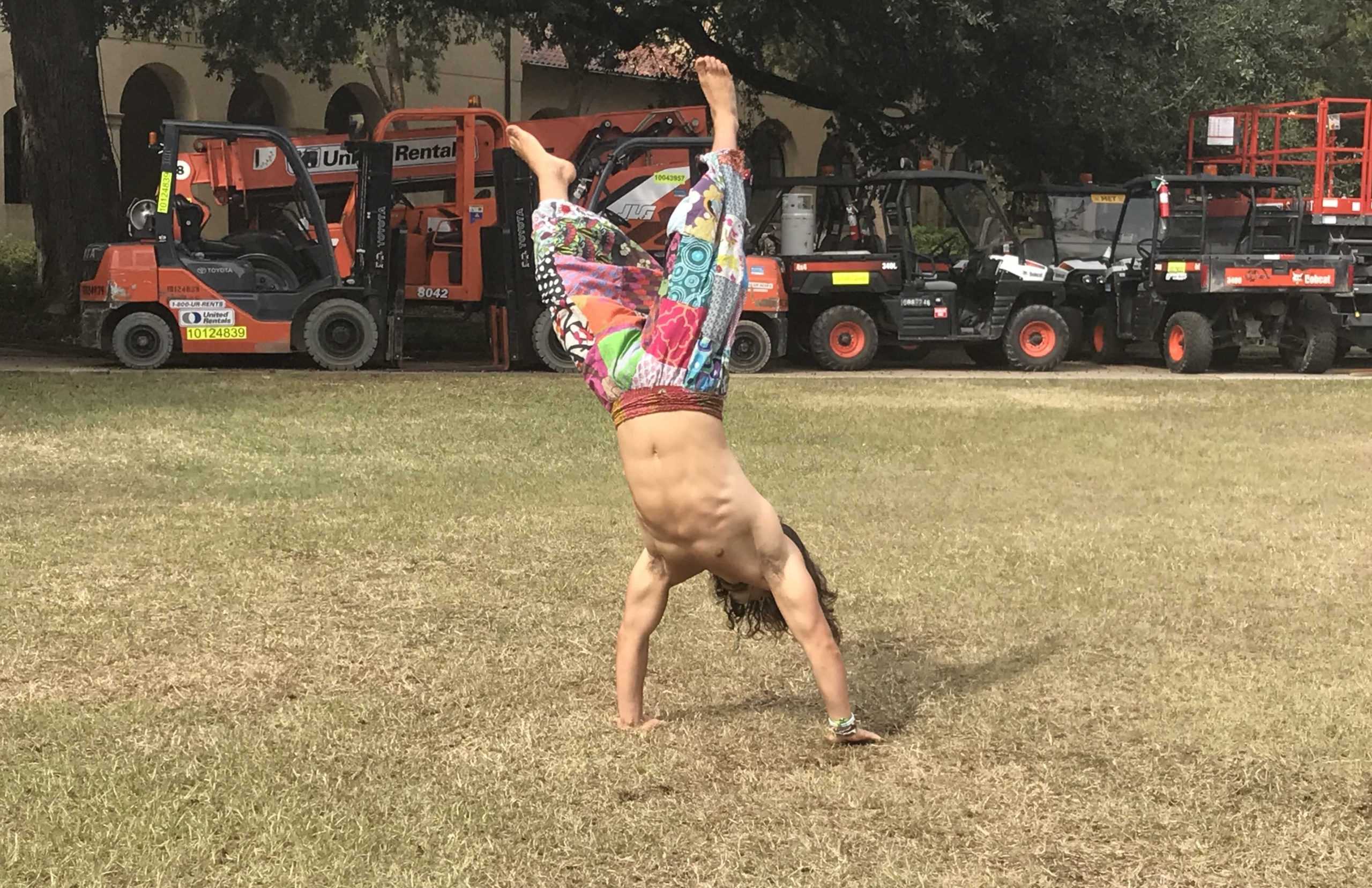 Communication studies student practices capoeira, gymnastics in Quad