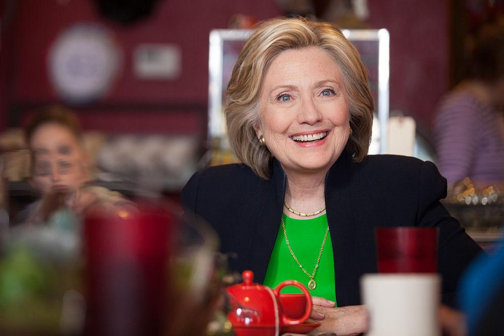 Hillary Clinton takes a break from conjuring spells in the woods to enjoy a scalding black cup of coffee.