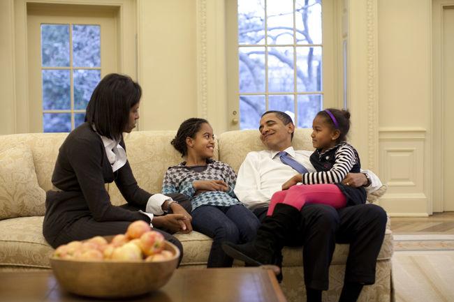 President Barack Obama relaxes on a sofa in the Oval Office with wife Michelle and daughters Malia and Sasha, Feb. 2, 2009.&#160;