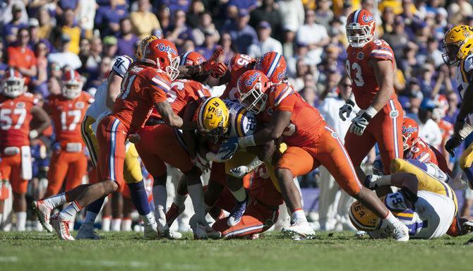 LSU junior running back Darrel Williams (28) carries a group of Florida Gators during the Tigers' 16-10 loss against the University of Florida on Saturday, Nov. 19, 2016 at Tiger Stadium.