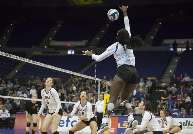 LSU junior outside hitter Gina Tillis (12) spikes the ball during the Tigers' 3-0 win against Mississippi State on Nov. 13, 2016 in the PMAC.