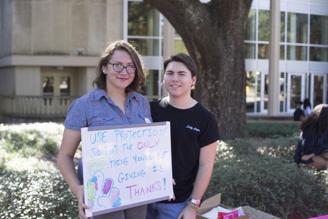 Biology junior Abby Hogan and mass communication sophomore Jack Stallard man the Planned Parenthood Generation Action group table during Free Condom Friday on Nov. 18, 2016&#160;in Free Speech Plaza.