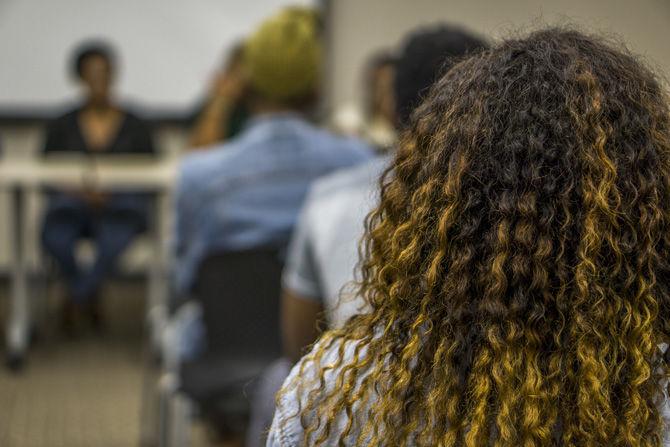 An attendant listens to the panel during the Dont Touch My Hair arts showcase and forum put on by the Black Artist Initiative on Nov. 17, 2016 at the African American Cultural Center.