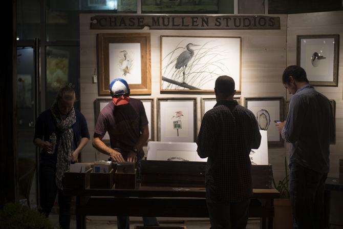 Artist Chase Mullen displays his work for festival attendees on Nov. 18, 2016 during this year's White Light Night art festival in The Market at Circa 1857 in the Mid City Cultural District.