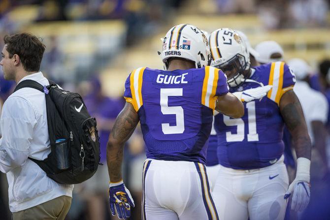 LSU sophomore running back Derrius Guice (5) and junior linebacker Jonathan Rucker (51) after entering the field before the LSU 45-10 win against Southern Mississippi on Saturday Oct. 15, 2016, in Tiger Stadium.