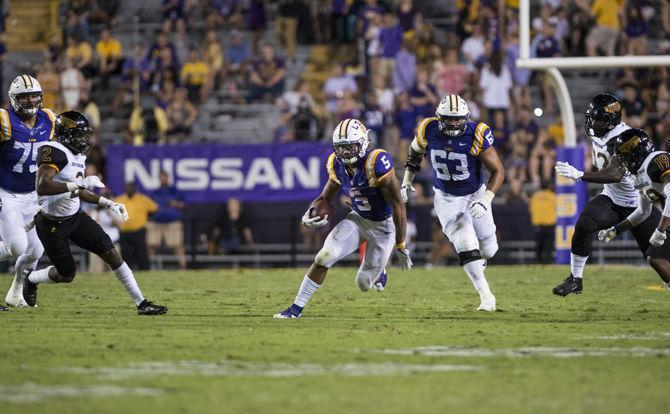 LSU sophomore running back Derrius Guice (5) runs through a hole in the Eagles defense during the LSU 45-10 win against Southern Mississippi on Saturday Oct. 15, 2016, in Tiger Stadium.