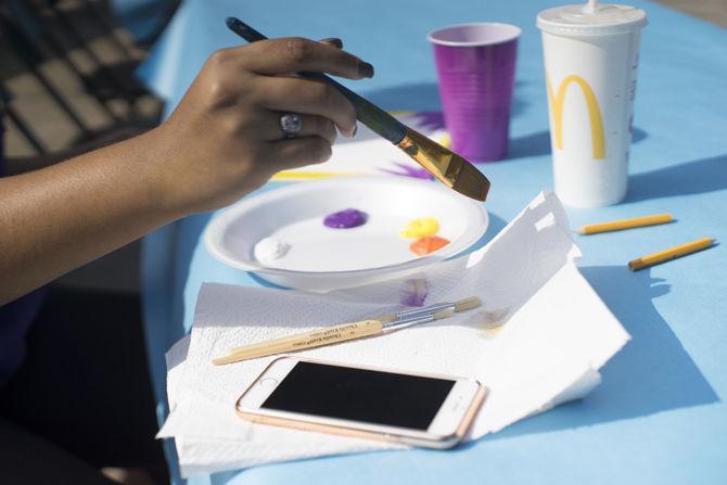 LSU student Kaitlyn Calais stops by the SAB's Painting on the Geaux session to take a break and make some art on Nov. 15, 2016 at Free Speech Circle just in front of the LSU Student Union.