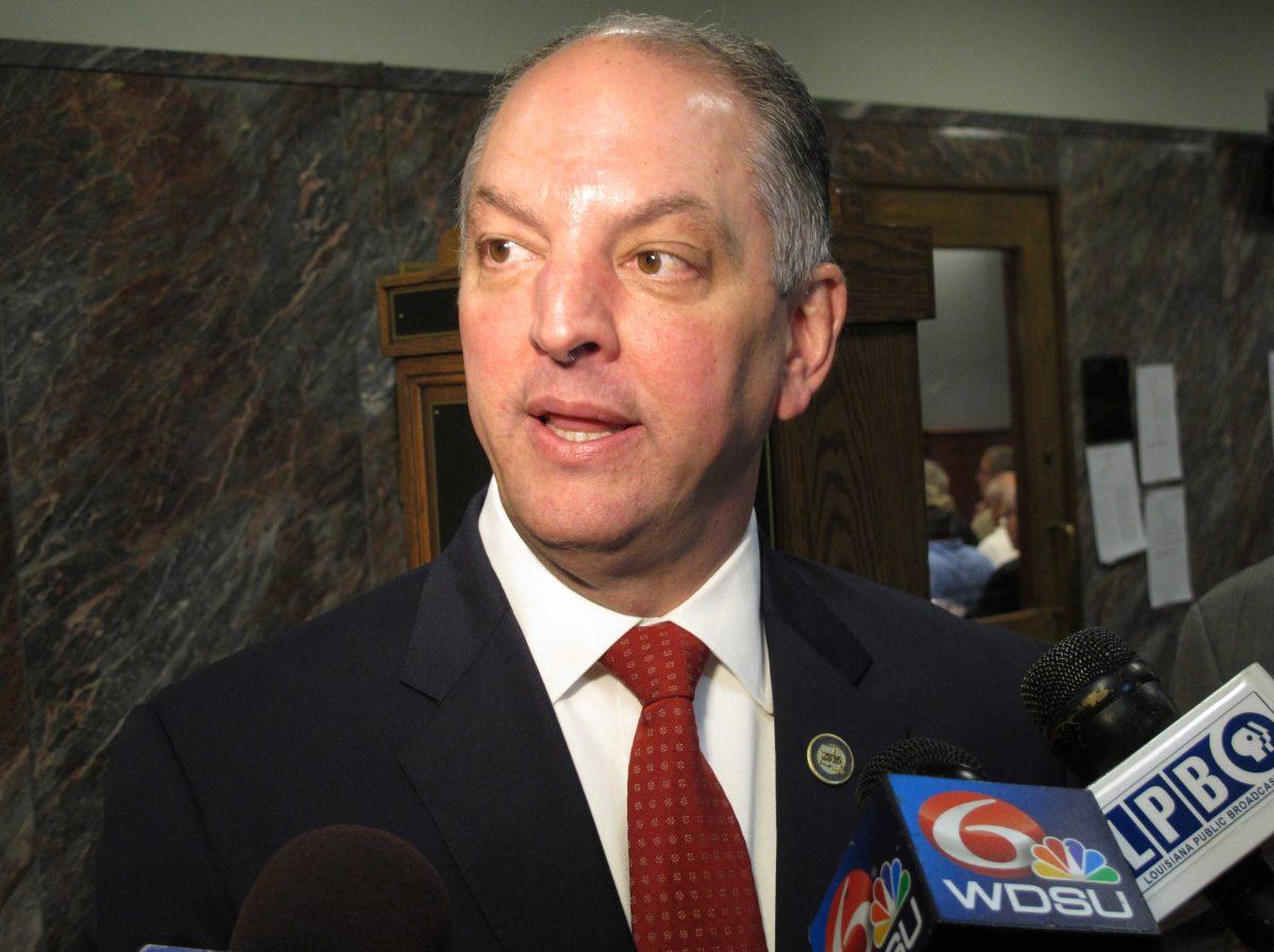 Louisiana Gov. John Bel Edwards talks with reporters about his budget cut proposal for the upcoming fiscal year after speaking to the House Appropriations Committee, Tuesday, April 12, 2016, in Baton Rouge, La. Edwards is proposing to close a $750 million budget shortfall with cuts to the TOPS free college tuition program, safety net hospitals for the poor and public schools. (AP Photo/Melinda Deslatte)