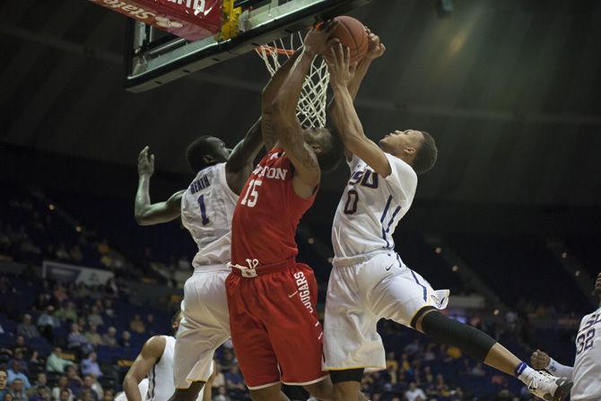 LSU junior forward Duop Reath (1) and sophomore guard Brandon Sampson (0) block Houston junior forward Devin Davis' (15) shot during the Tigers' 84-65 win against the University of Houston on Tuesday, Nov. 29, 2016 in the Pete Maravich Assembly Center.