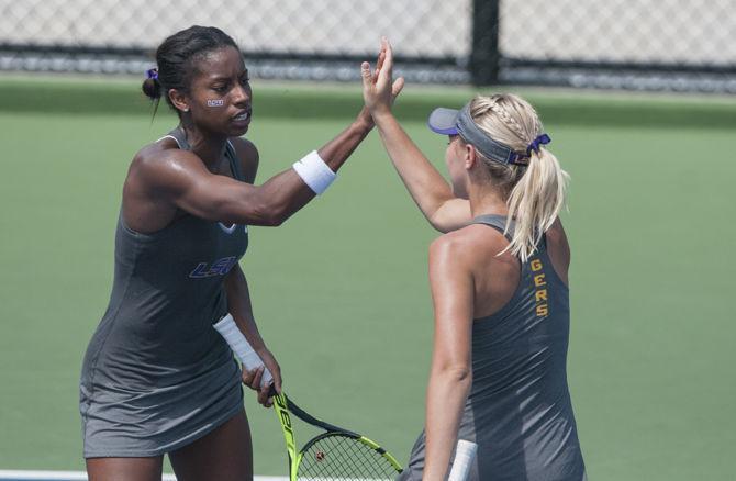 LSU junior Skylar Holloway high fives partner senior Skylar Kuykendall during the Tigers' 4-3 victory against Kentucky in the SEC Championship on Thursday, April 21, 2016 at the LSU Tennis Complex.