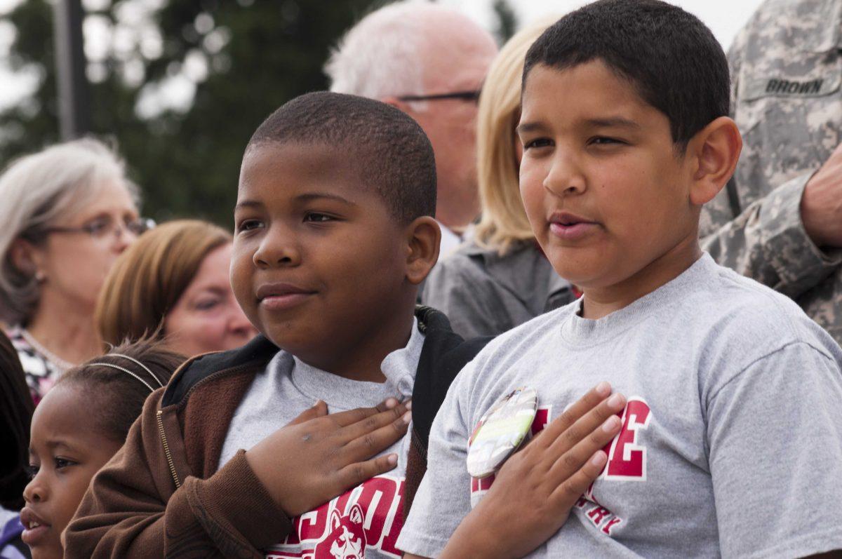 Children recite the Pledge of Allegiance during a groundbreaking ceremony at Joint Base Lewis-McChord, Wash. signifying the official start of a yearlong construction project to completely rebuild the installation's Hillside and Carter Lake Elementary Schools in the Clover Park School District, July 30, 2012.&#160;