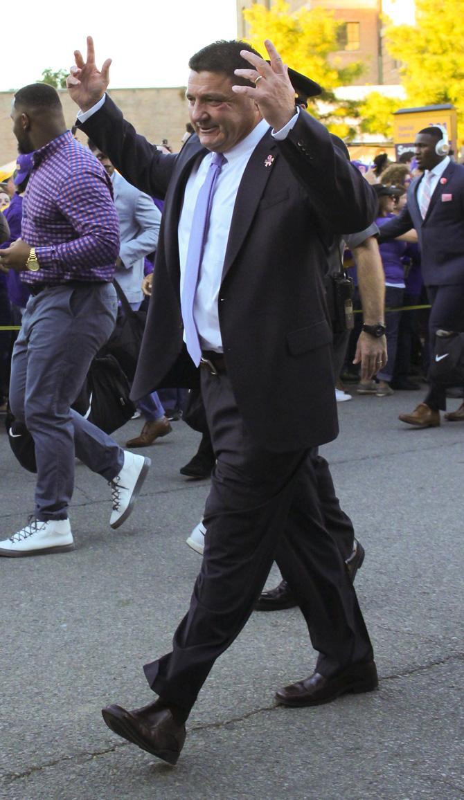 LSU head coach Ed Orgeron walks with the team down Stadium Rd. on Saturday, Oct. 22, 2016 before the Tigers 38-21 victory over Ole Miss.