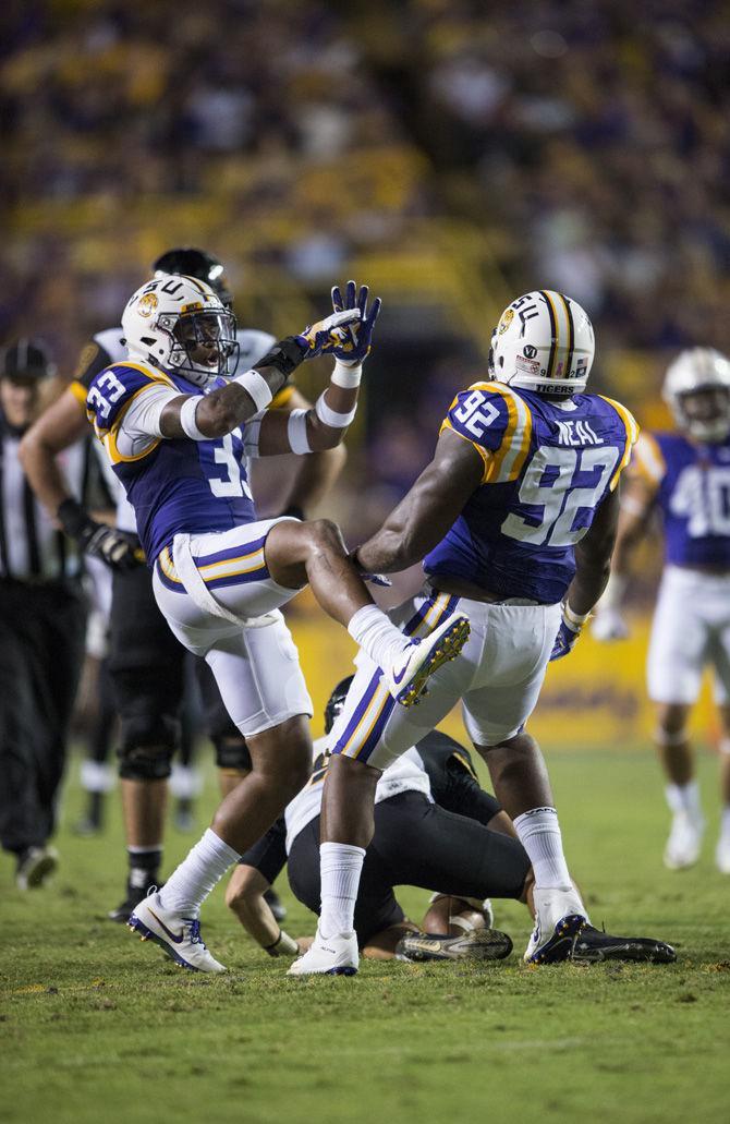 LSU junior safety Jamal Adams (33) celebrates after senior defensive end Lewis Neal (92) successfully sacks Eagles senior quarterback Nick Mullens (9) during the LSU 45-10 win against Southern Mississippi on Saturday Oct. 15, 2016, in Tiger Stadium.