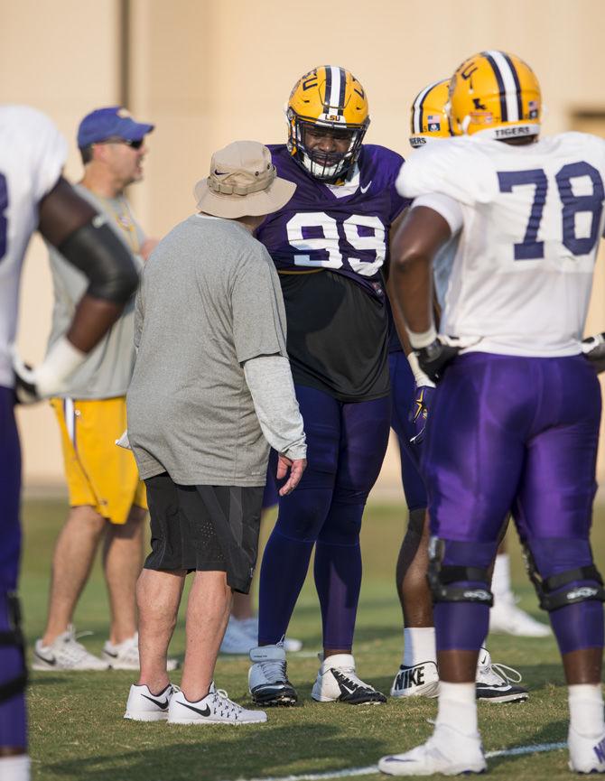 LSU junior defensive tackle Greg Gilmore (99) talks with Pete Jenkins during an outdoor practice on Tuesday Sept. 27, 2016, on the LSU footbal practice fields at the LSU Football Practice and Training Facilities.