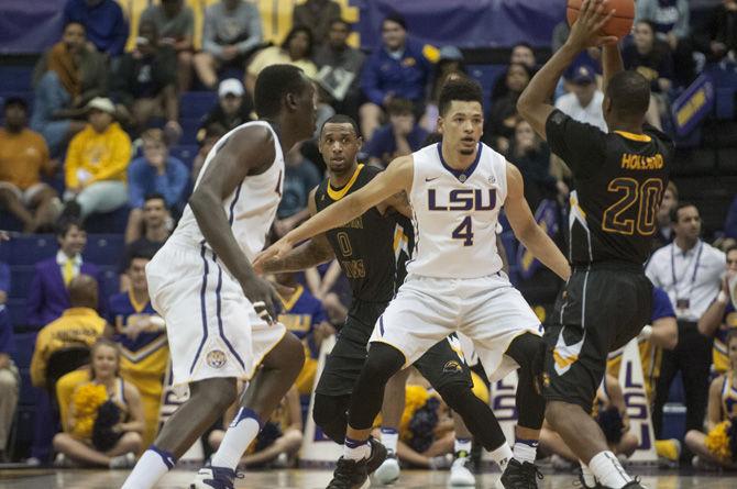 LSU freshman guard Skylar Mays (4) and junior forward Duop Reath (1) guard Sourthern Miss sophomore guard Kevin Holland (20) during the Tigers' 61-78 win against Southern Miss&#160;on Nov. 15, 2016 in the Pete Maravich Assembly Center.