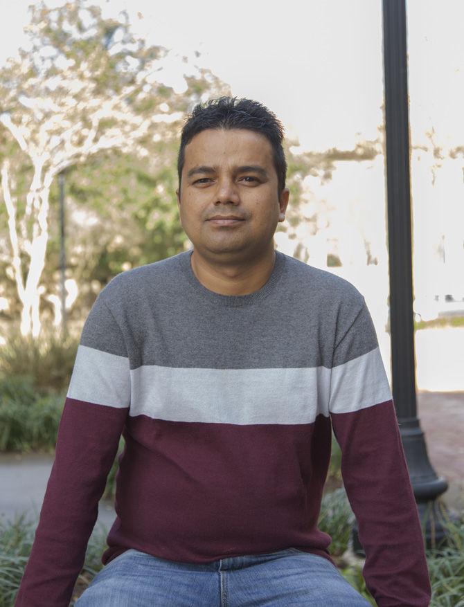 Sanjeev Joshi, a Ph.D. candidate in the School of Renewable Natural Resources, sits outside the University bookstore on Wednesday, Jan. 11, 2017. Joshi created a petition to change the University's health insurance policy.&#160;