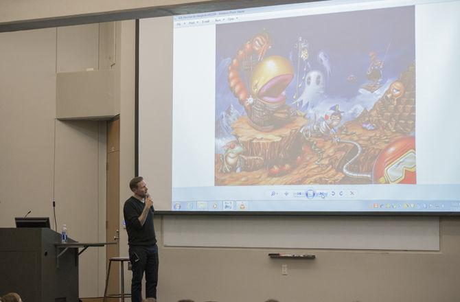 Greg 'CRAOLA' Simkins, a surrealist painter describes one of his works to LSU faculty and students on Monday Jan. 23, 2017 in the Art &amp; Design Building.