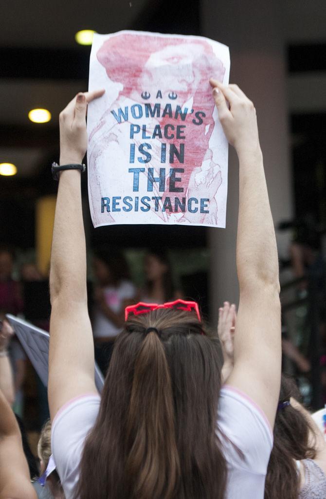 An attendee holds up a sign in the crowd during the Women's March on Jan. 21, 2017, at Duncan Plaza in New Orleans.