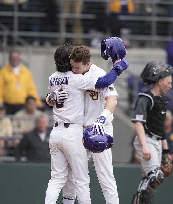 LSU senior infielder Kramer Robertson (3) hugs junior infielder Greg Deichmann (7) celebrating his home run during the Tigers' 9-0 win against Army on Saturday, Feb. 18, 2017 at Alex Box Stadium.