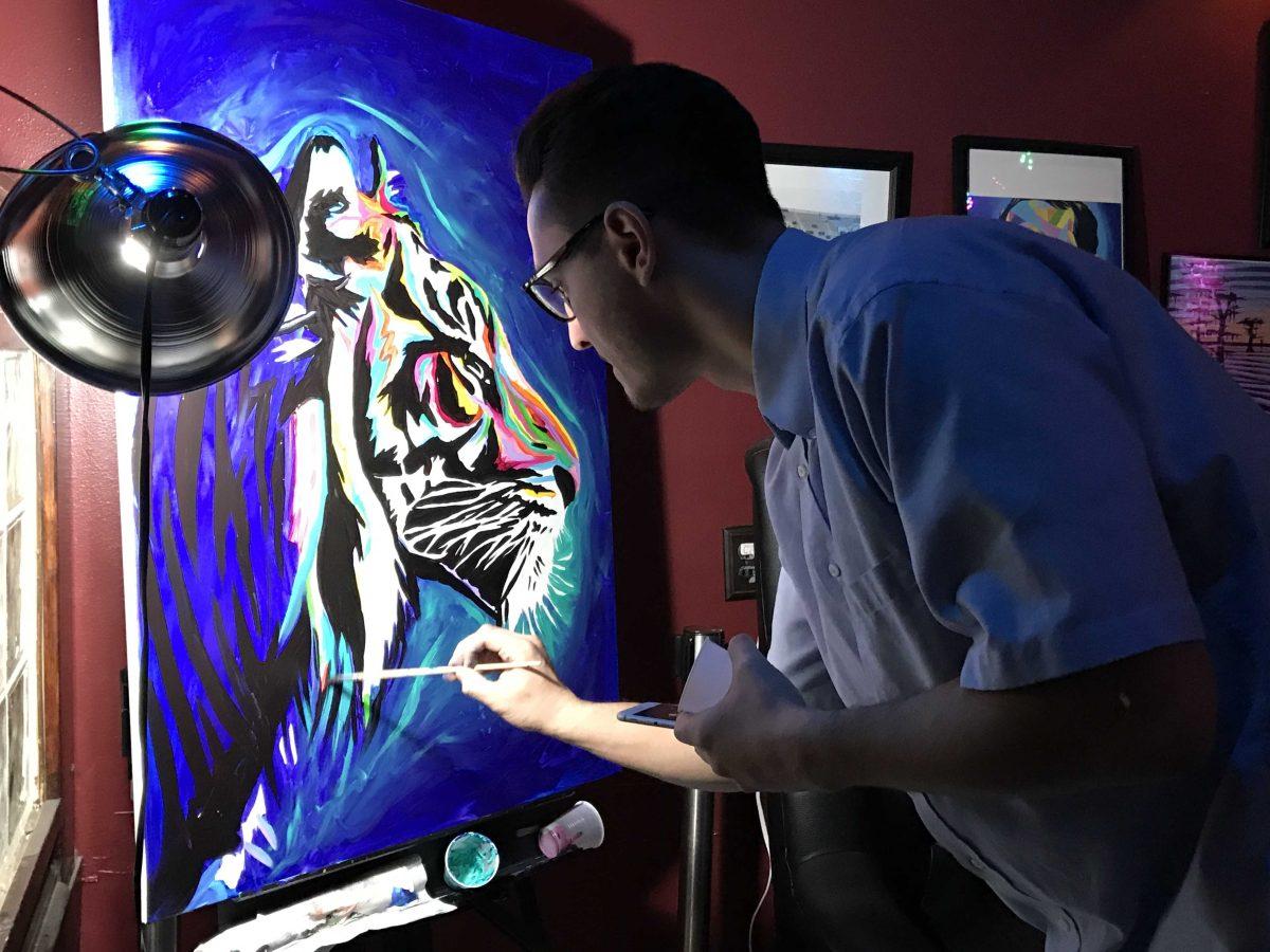 David "D-Lo" Losavio works on a live painting at a fundraising event.