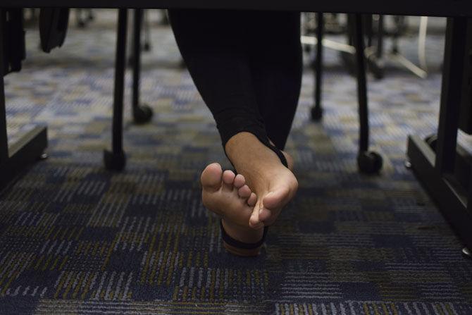 A University student sits barefoot&#160;in a classroom on Thursday, Feb. 2, 2017, in Hodges Hall.