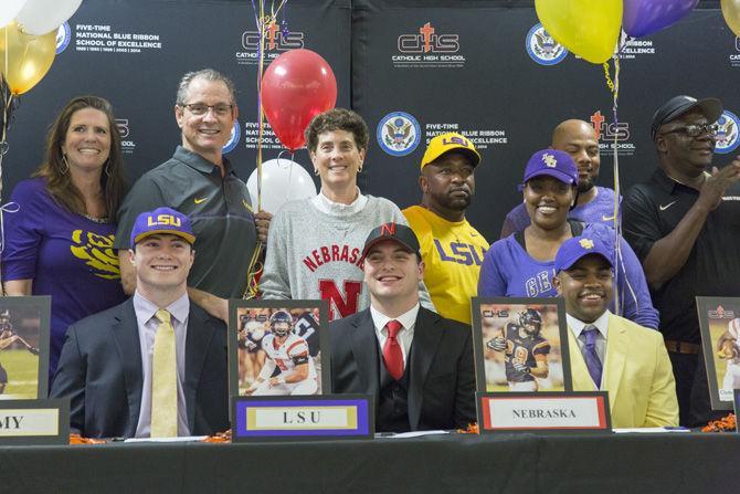 LSU commits Aaron Moffitt (left) and Clyde Edwards-Helaire (right) and Nebraska commit Ben Miles (middle) celebrate their commitment to play football on Wednesday, Feb. 1, 2017 at Catholic High School.