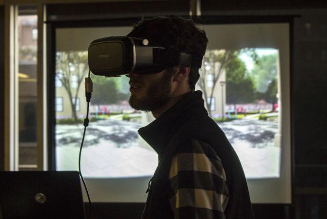 A student interacts with a virtual reality simulation of the future campus proposals in the Student Union on Feb. 15, 2017.