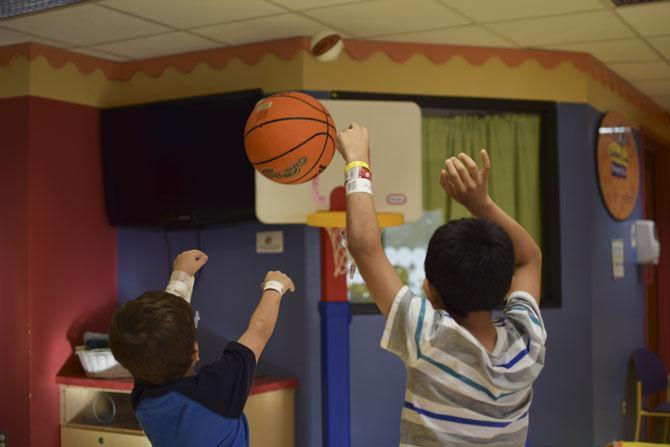 James Roussa (left) and Ever Ayala (right) shoot basketballs together on Thursday, Feb. 9, 2017, in the playroom of the Our Lady of the Lake Children's Hospital.