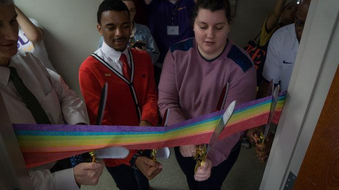 Mass communication Senior Jonathan R. Brown (left) and LSU Graduate Assistant for the LGBTQ Project &amp; Safe Space Campaign Karie (right) cut the ribbon during the new LGBTQ center opening ceremony on Wednesday, Feb. 22, 2017, in the Women&#8217;s Center.