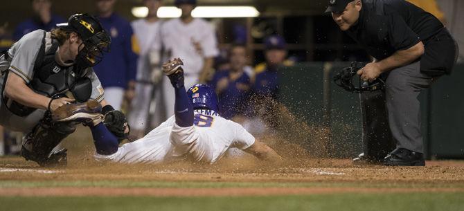 LSU senior infielder Cole Freeman (8) slides into home plate before being tagged during the 6-1 win against Wichita State University on Friday, March 10, 2017 at Alex Box Stadium.