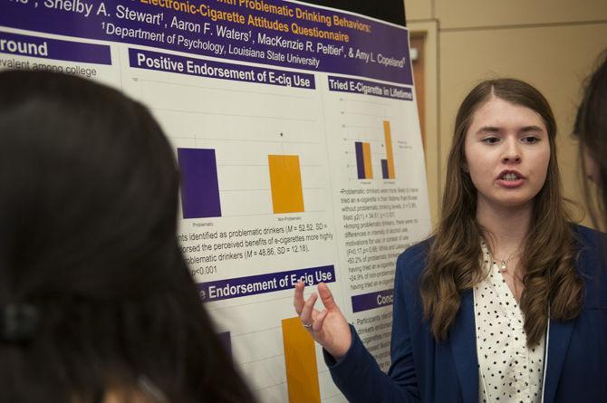 Psychology and sociology junior Katherine Davis explains her display titled &#8220;E-Cigarette Use in College Students with Problematic Drinking Behaviors: Validating the Electronic-Cigarette Attitudes Questionnaire&#8221; Thursday, April 7, 2016 during LSU Discover Day in the LSU Student Union Royal Cotillion Ballroom.