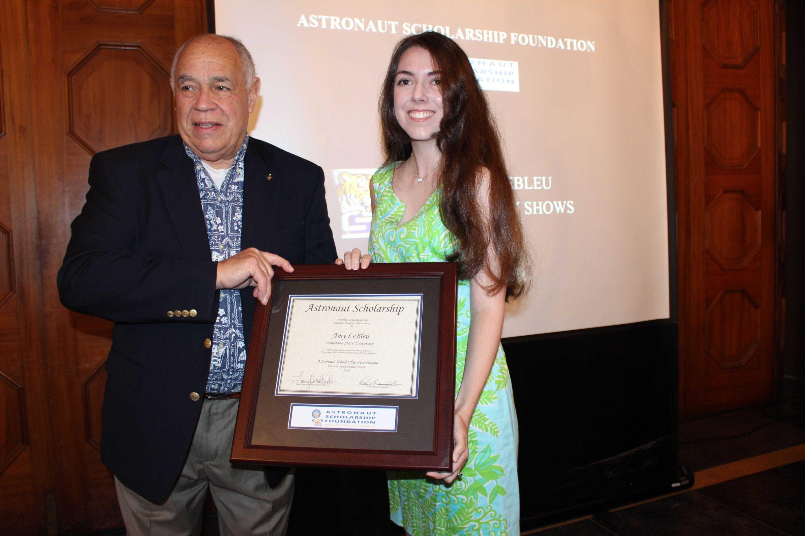 Former space shuttle commander presents two students with scholarships